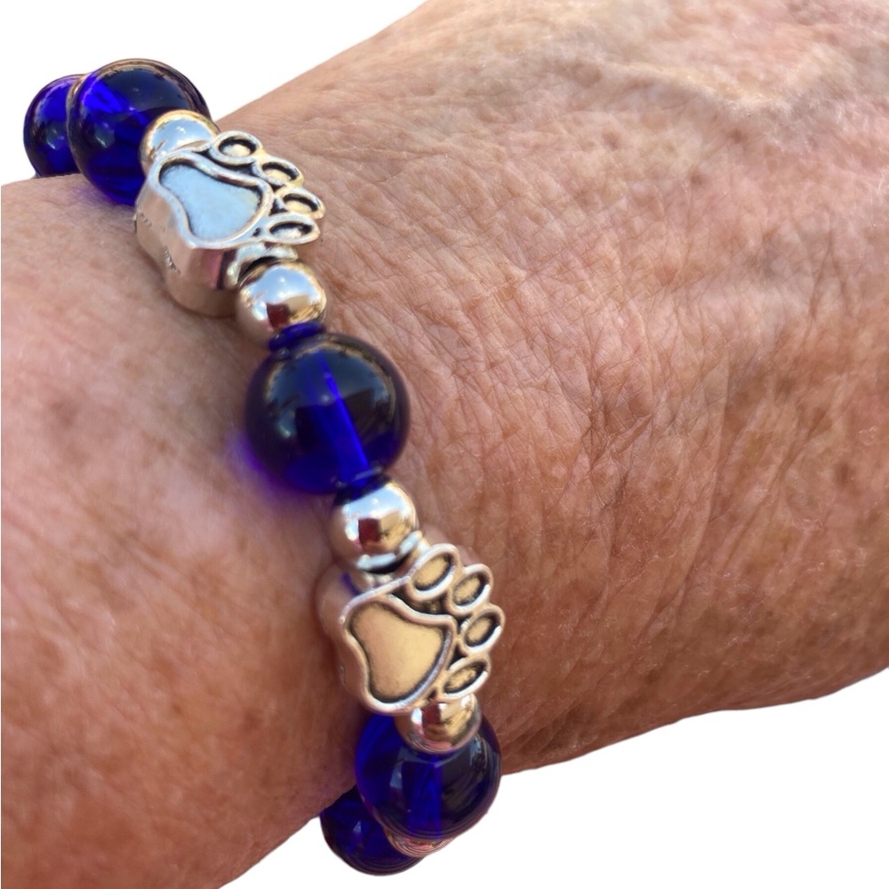 Bead bracelet with Paw Print blue translucent bead Silvertone stretch